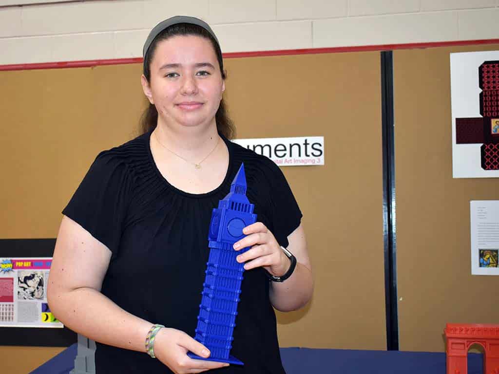 Female art student holding sculpture