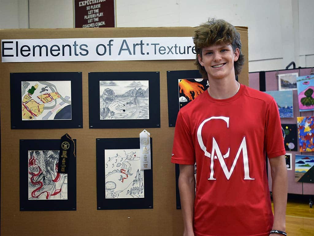 Male art student in front of art show