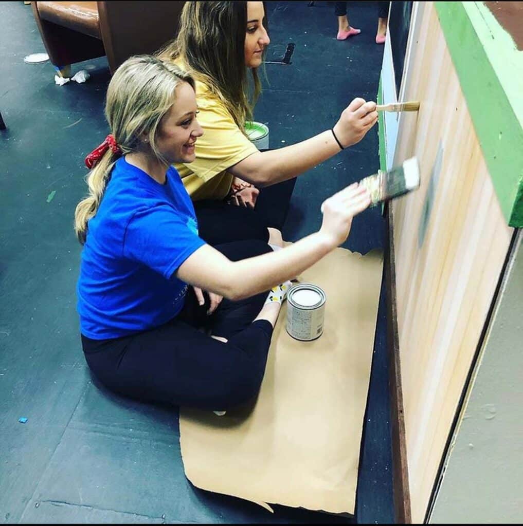 Drama students painting set