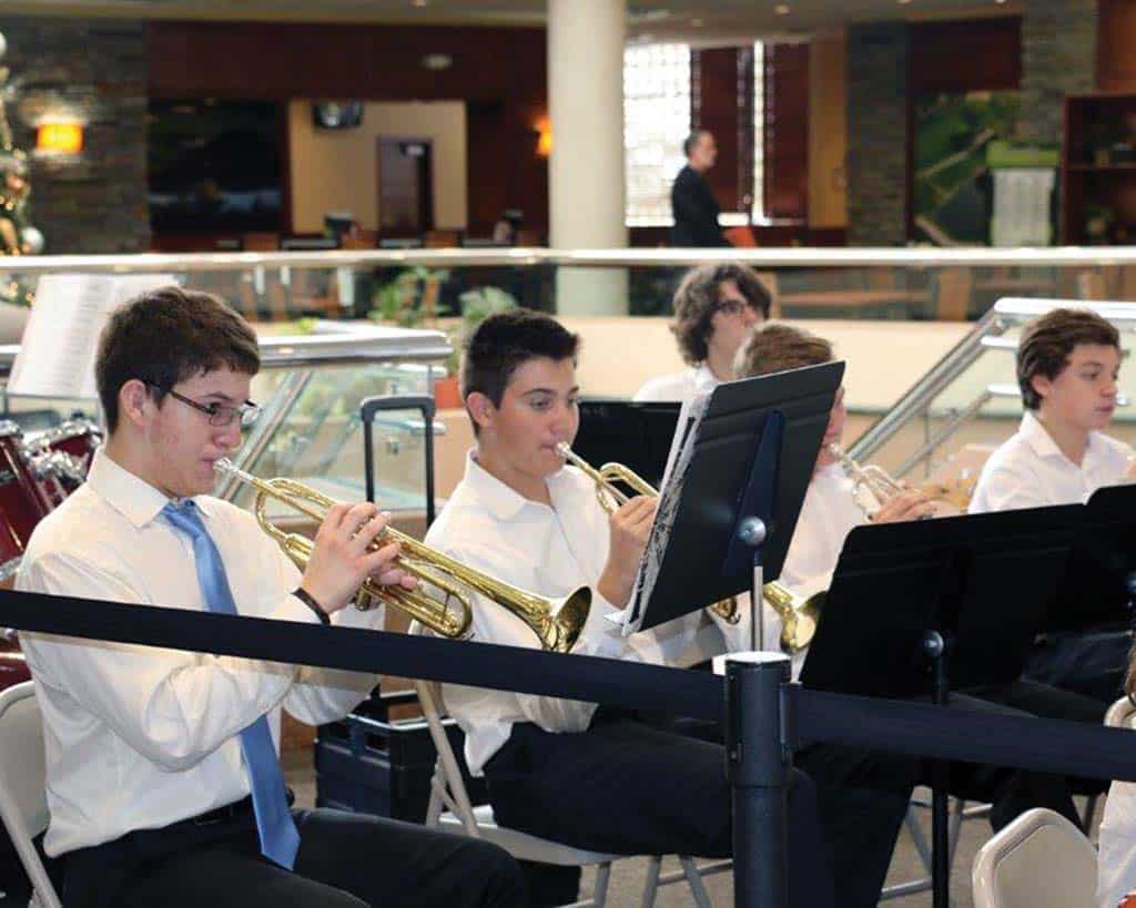 Male students playing trumpet