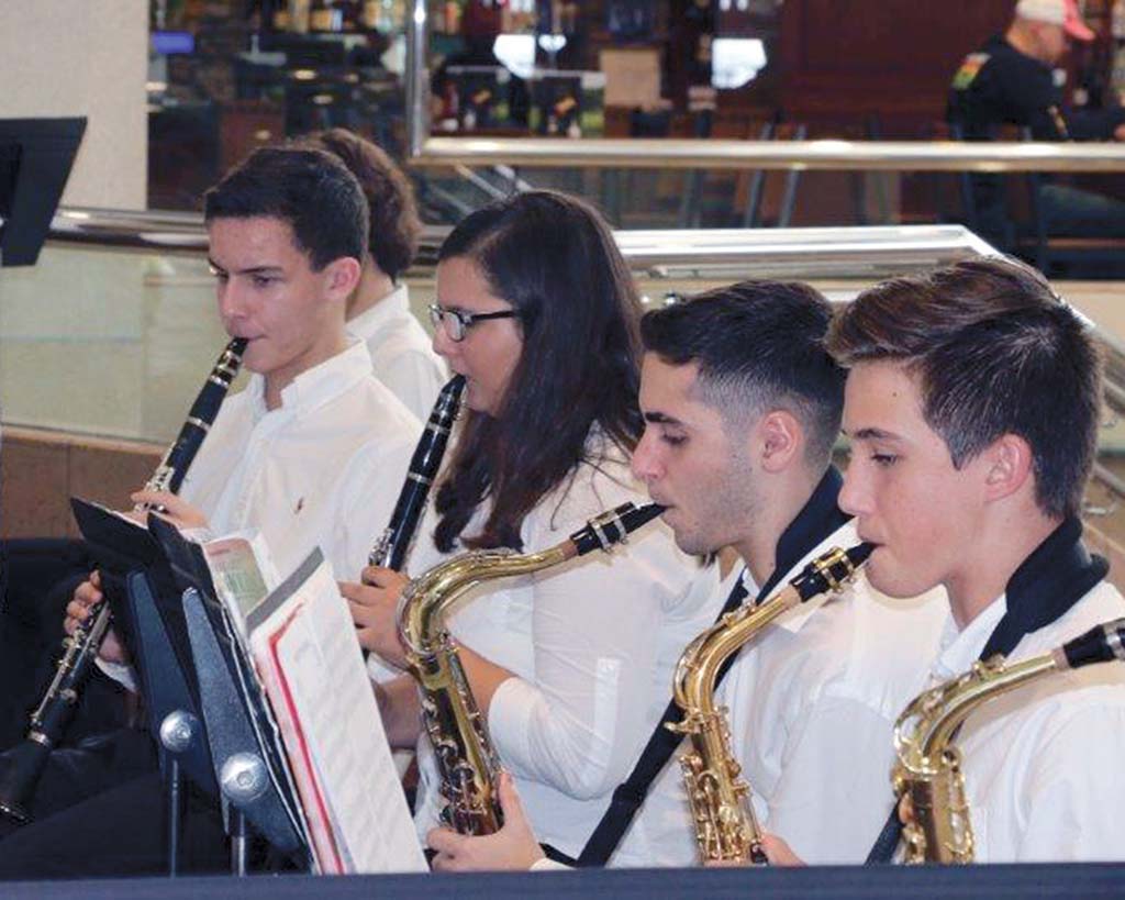 Male & female students playing trumpet